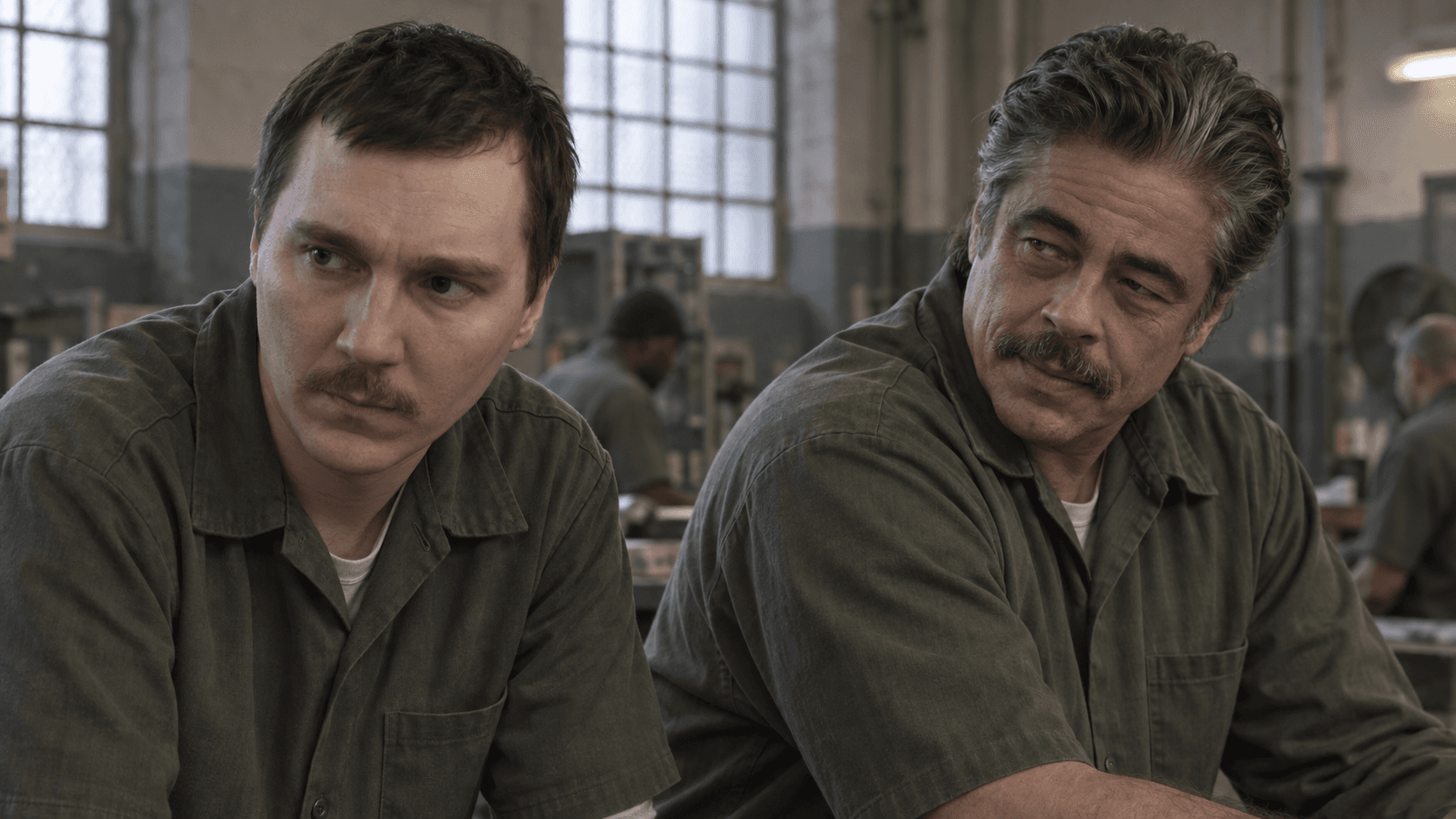 Paul Dano as David Sweat and Benicio del Toro as Richard Matt in olive prison work shirts.